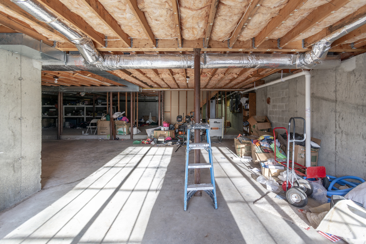 Before basement remodeling at Smith Residence in Brookfield CT showing unfinished basement before remodeling